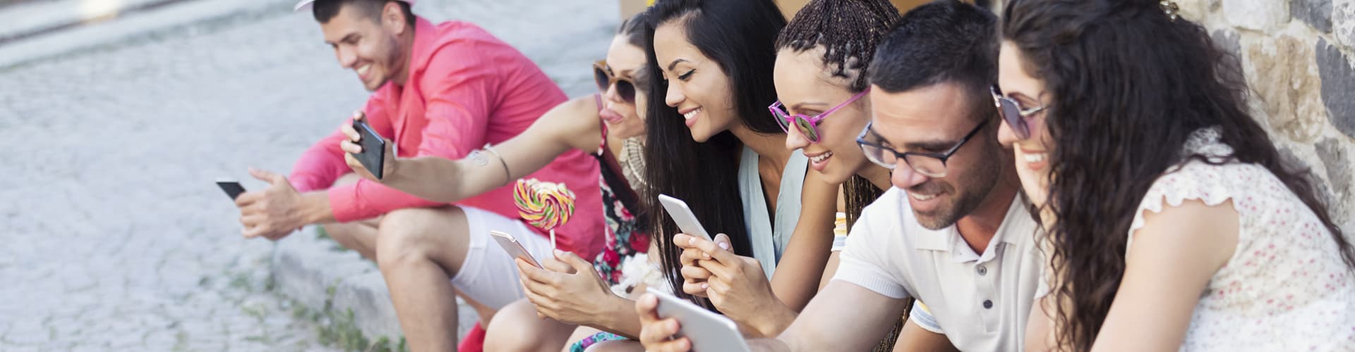 Group of youngsters looking at their mobile phones