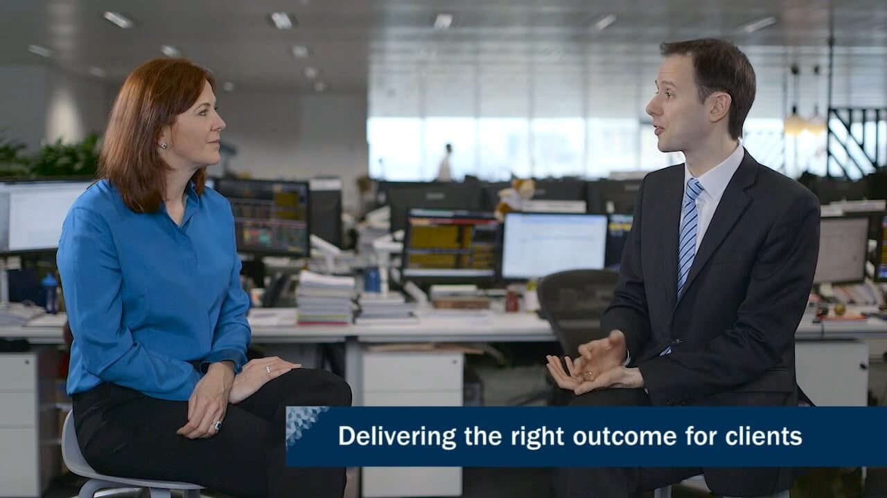 A photo showing two people talking