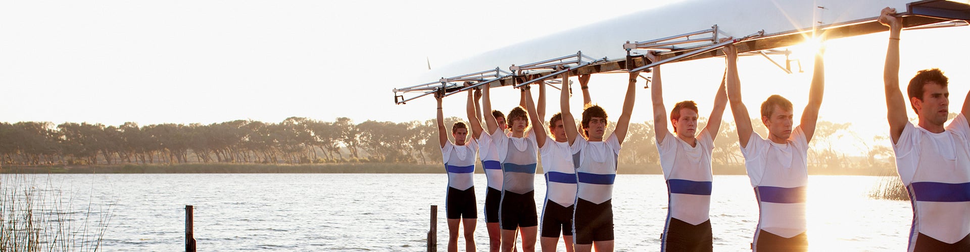 Rowing team is carrying the canoe