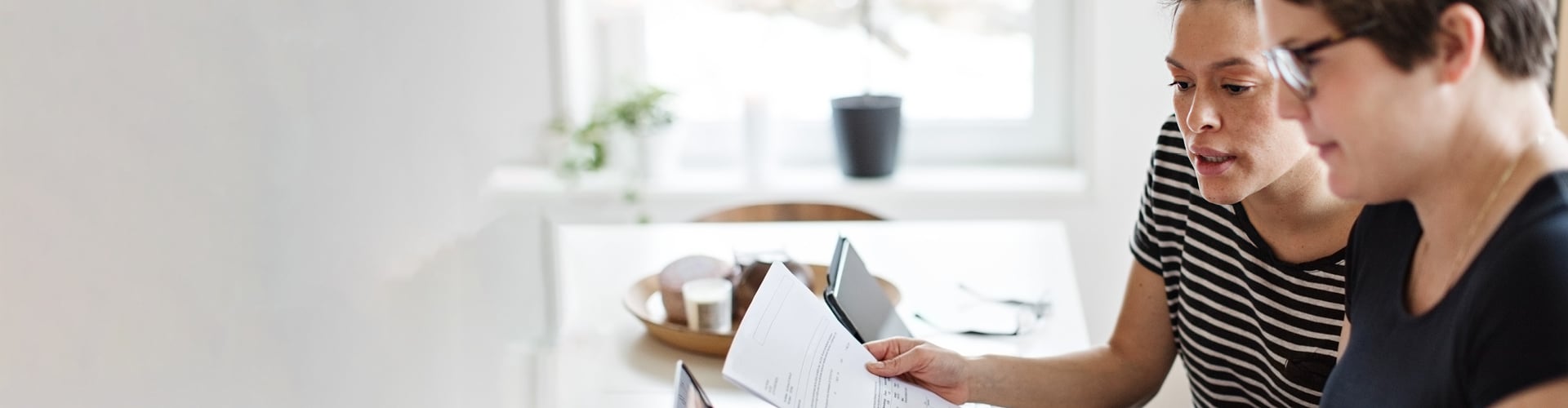 Two women read documents