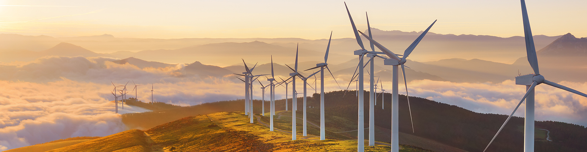 Wind turbines on hills at sunrise