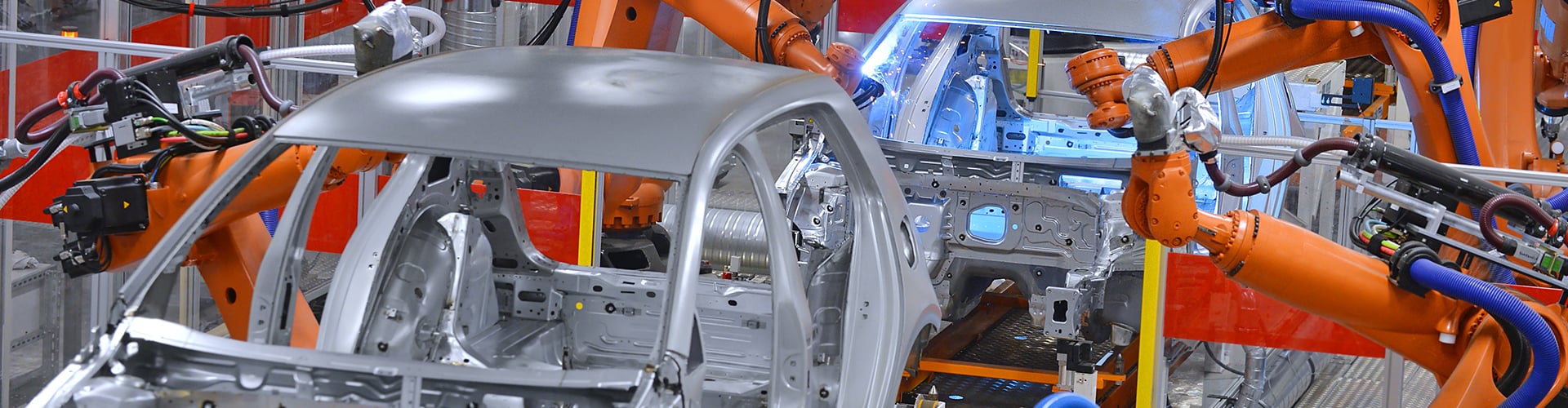Cars being built on assembly line