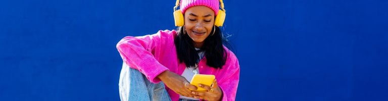 Woman listens to music through headphones