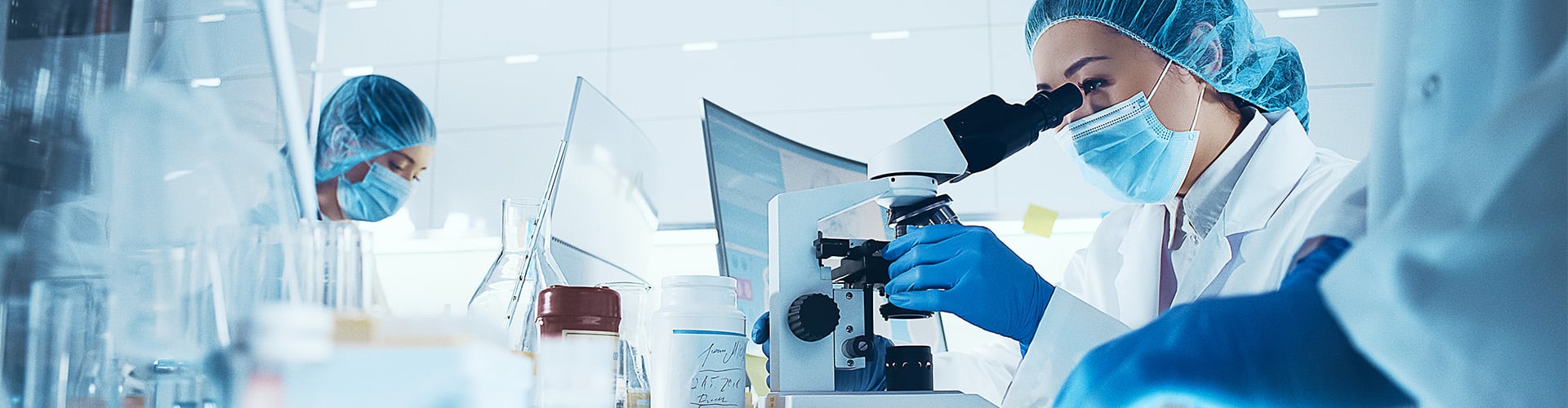 Doctor looking through microscope