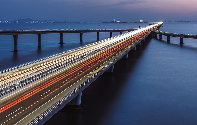 Bridge lit at night over water