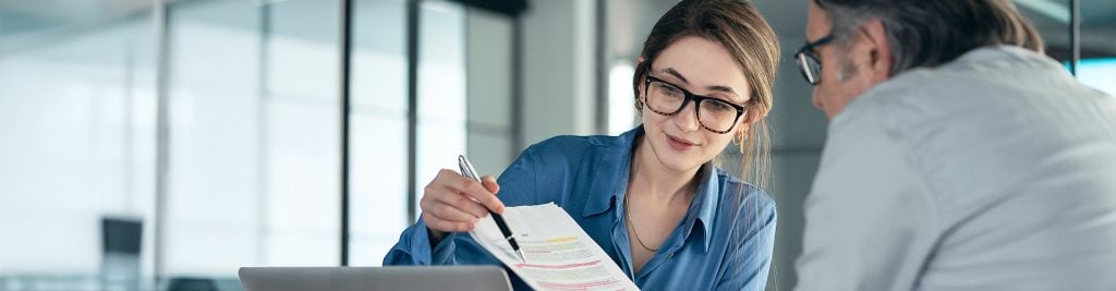 Woman and man discussing document in office
