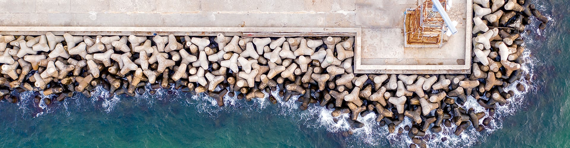 Aerial view of rock buffer against sea waves