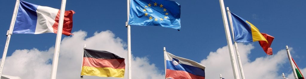 European flags waving in a beautiful blue sky