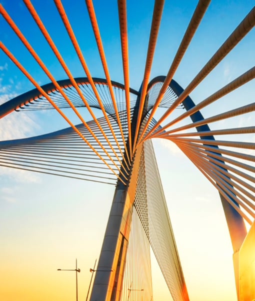 Spiral structure of a bridge against a sunny sky