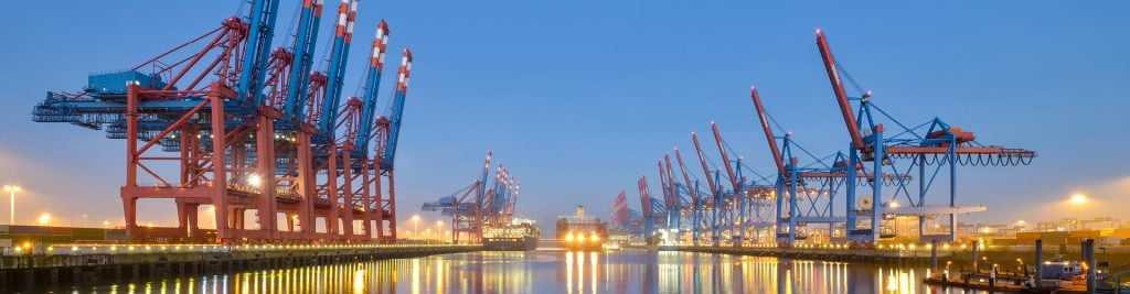 Industrial port lit up at sunset