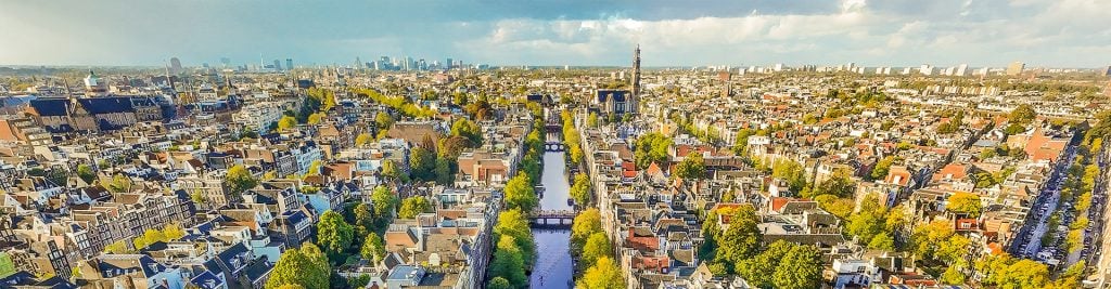 Aerial view of the buildings, water and bridges in Amsterdam on a sunny day