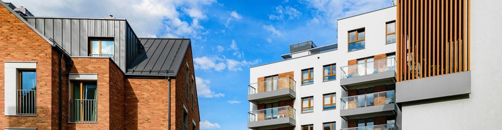 View of modern residential real estate against a sunny blue sky backdrop
