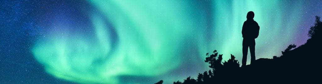 Person looking up at the Aurora Borealis/Northern Lights